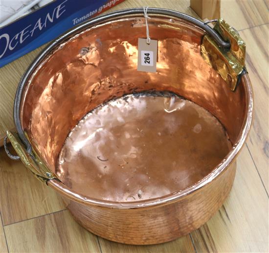 A 19th century French copper and brass cauldron